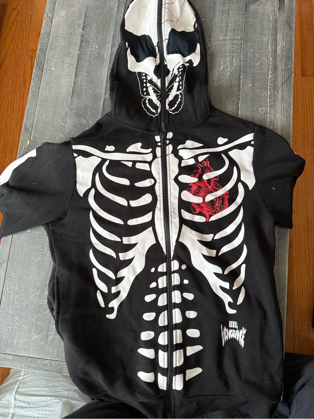 Black Zip-Up Hoodie with White Skeleton and Red Heart Graphic
